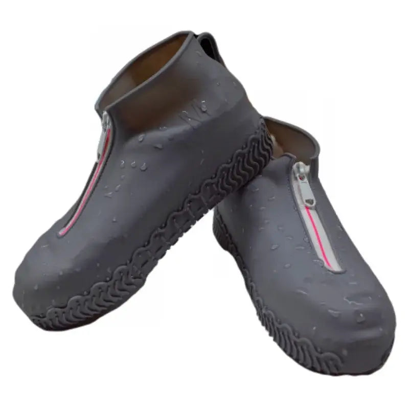 Waterproof silicone zippered shoe covers in grey, showcasing non-slip sole and water droplets for protection.